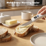 Hand holding USB rechargeable heated butter knife spreading softened butter onto artisan bread slice on kitchen counter; lifestyle morning use