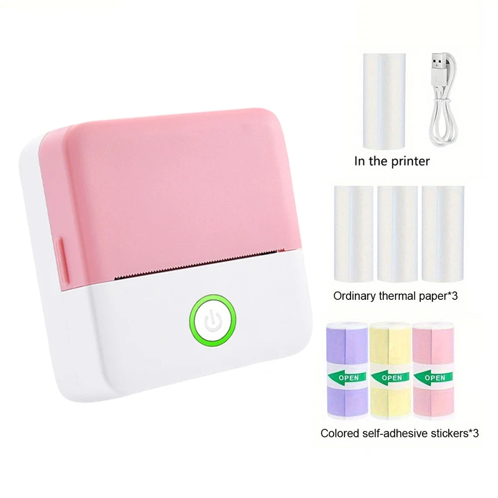 Pink portable thermal pocket printer with 3 thermal paper rolls, 3 colored self-adhesive sticker rolls, and USB cable package contents