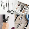 Four lifestyle views of digital thermometer stored in kitchen: hanging on wall rail with utensils, in cutlery drawer, in knife block, and beside whisk and pan on countertop