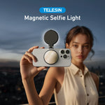 TELESIN magnetic selfie light attached to back of iPhone held by woman outdoors at dusk with city skyline in background
