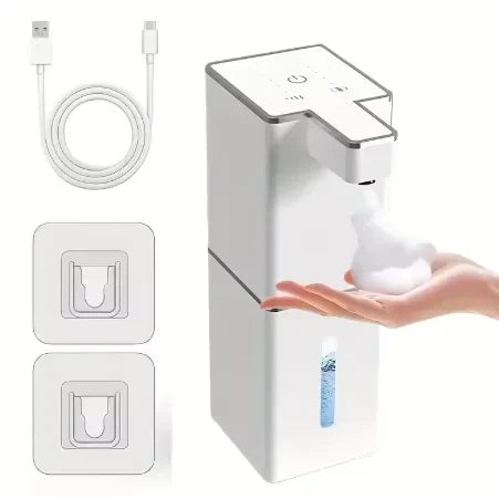 USB rechargeable automatic foam soap dispenser in white with USB charging cable and two adhesive wall mount brackets, dispensing foam soap into hand