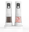 White electric salt and pepper grinder set with dual charging base, LED displays and fingerprint sensor buttons, clear chambers showing peppercorns and pink himalayan salt, on white background
