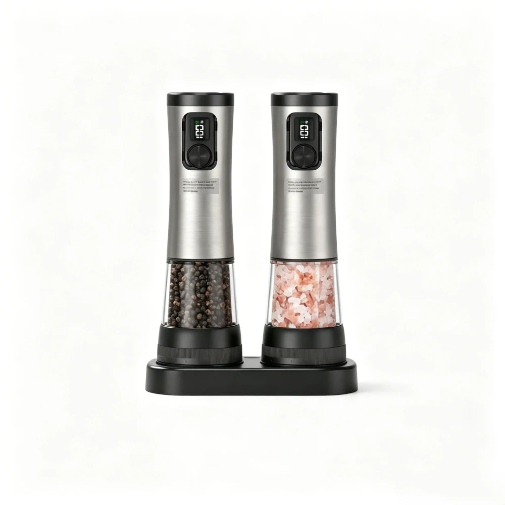 Stainless steel electric salt and pepper grinder set with dual charging base, LED displays and speed buttons, clear tapered chambers filled with peppercorns and pink himalayan salt, on white background
