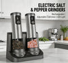 Electric salt and pepper grinder set: two stainless steel grinders with LED displays in dual charging base on kitchen counter; features rechargeable, adjustable coarseness, LED light