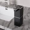 USB rechargeable automatic foam soap dispenser in black with silver trim on marble bathroom countertop next to sink