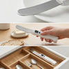 Three-panel image: close-up of stainless steel heated blade; hand holding knife to spread butter on bread next to butter dish; knife stored in wooden cutlery drawer
