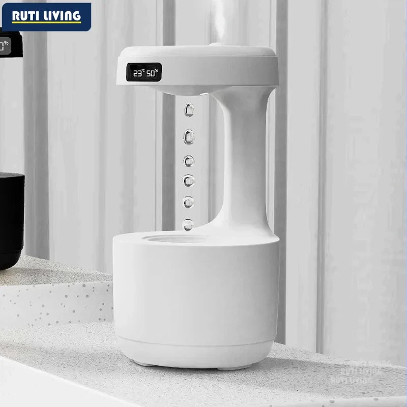 Anti-gravity humidifier with LED temperature and humidity display showing floating water drop effect on desk