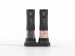 Black electric salt and pepper grinder set with dual charging base, LED displays and fingerprint sensor buttons, clear chambers showing peppercorns and pink himalayan salt, on white background