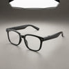 Black AI smart glasses with clear lenses, built-in camera on left temple, and hidden speakers in arms, product shot on gray background
